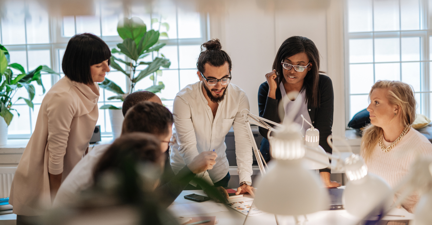 Collaborative team working together to review systems and workflows that show how MBM360 works