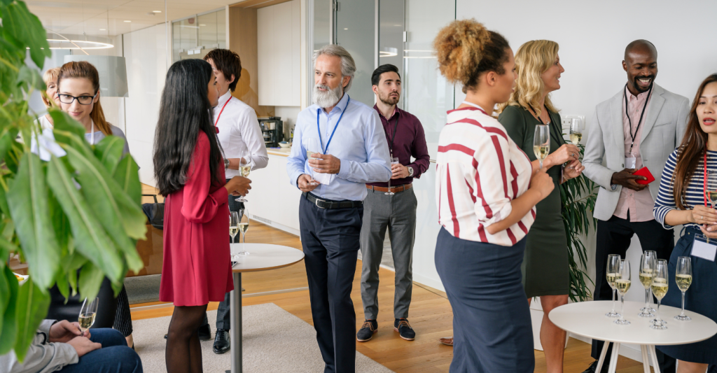 Business people socializing with champagne at office event