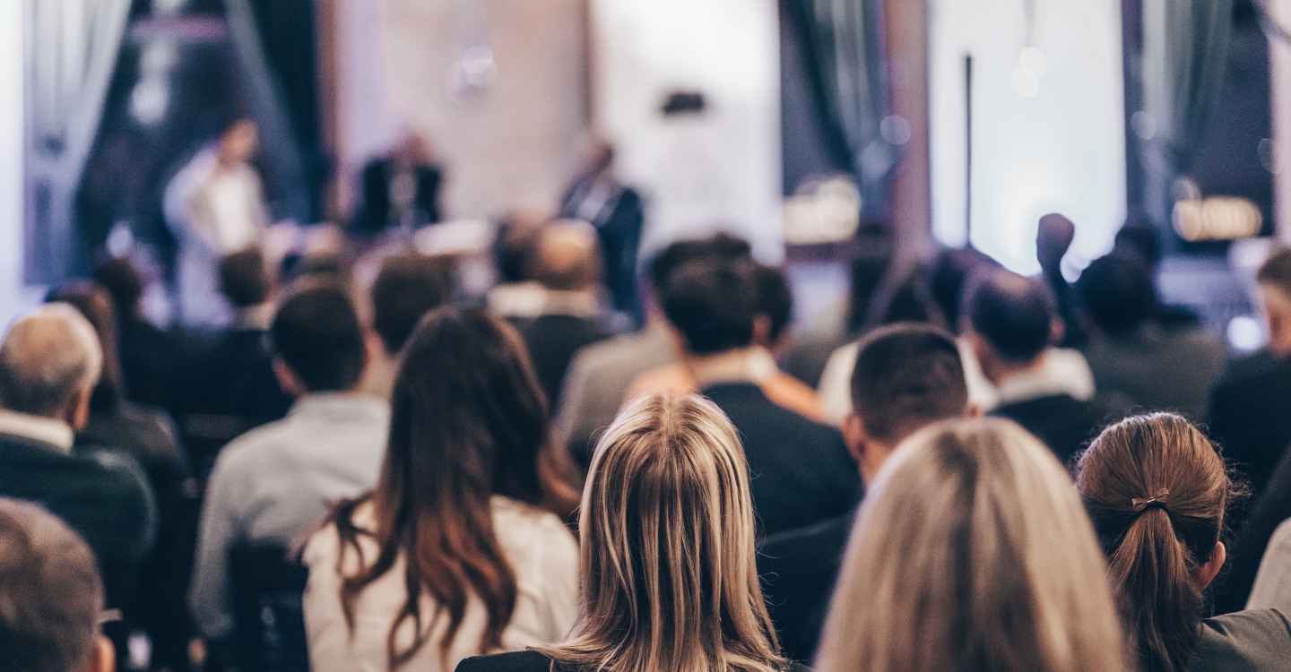Audience attending a professional conference highlighting events management solutions