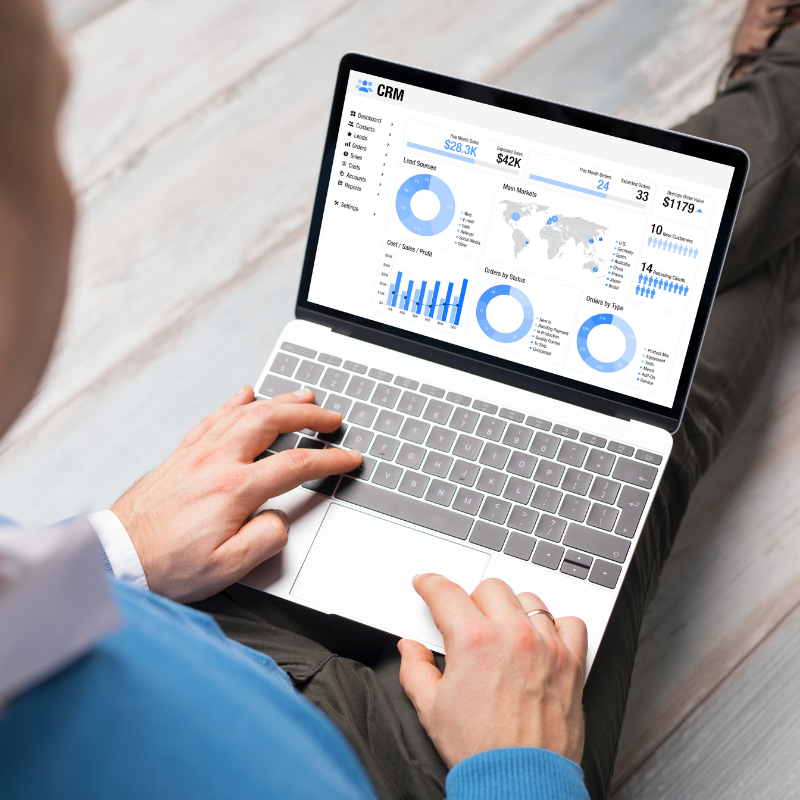 Person analyzing CRM dashboard with online tracking and performance reports.
