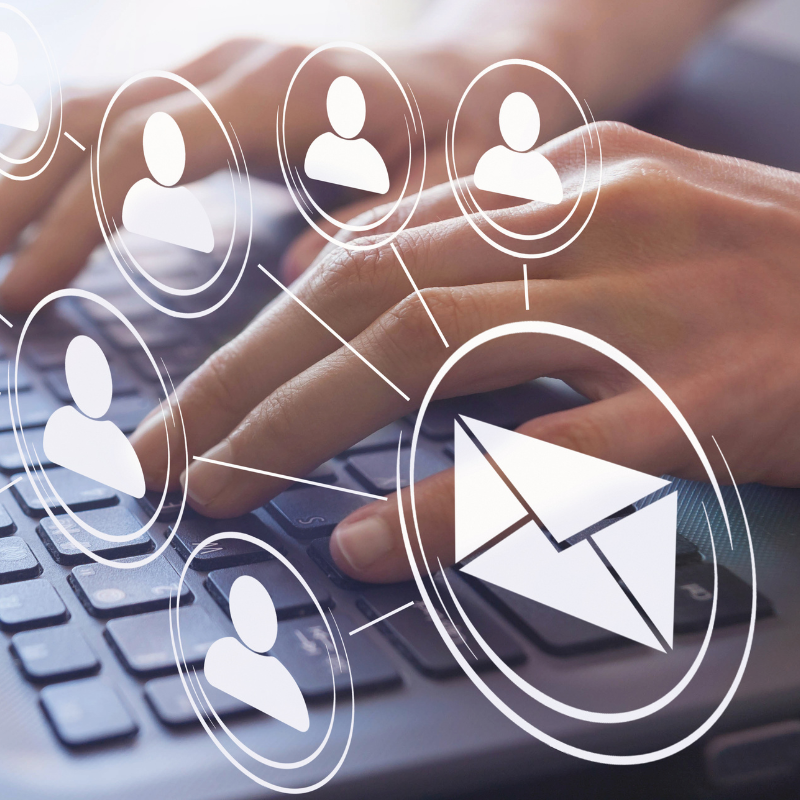 Email and SMS automations concept with hands typing on a keyboard surrounded by icons of users and an envelope symbol.