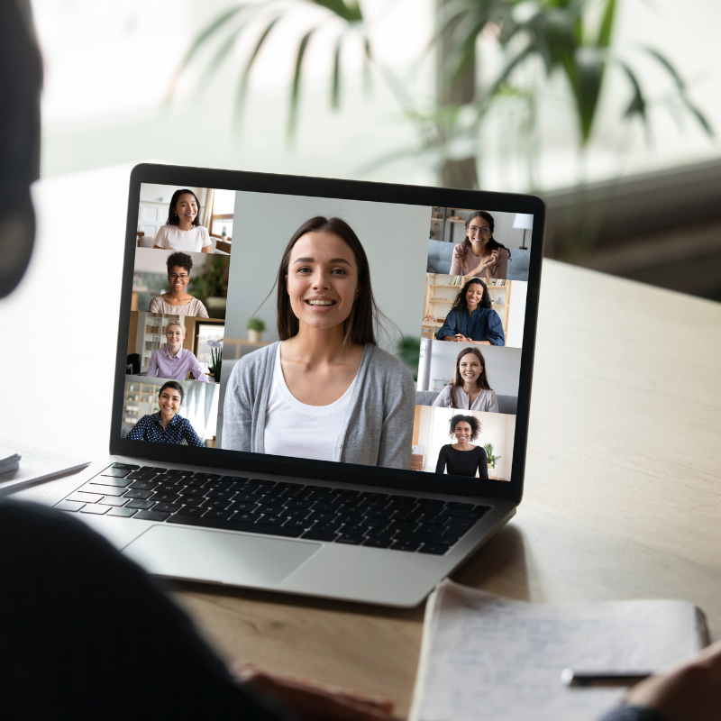 Online courses shown on a laptop screen with a diverse group of people engaged in a virtual learning session via video call.