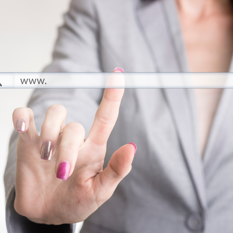 Business professional typing website address in browser search bar.